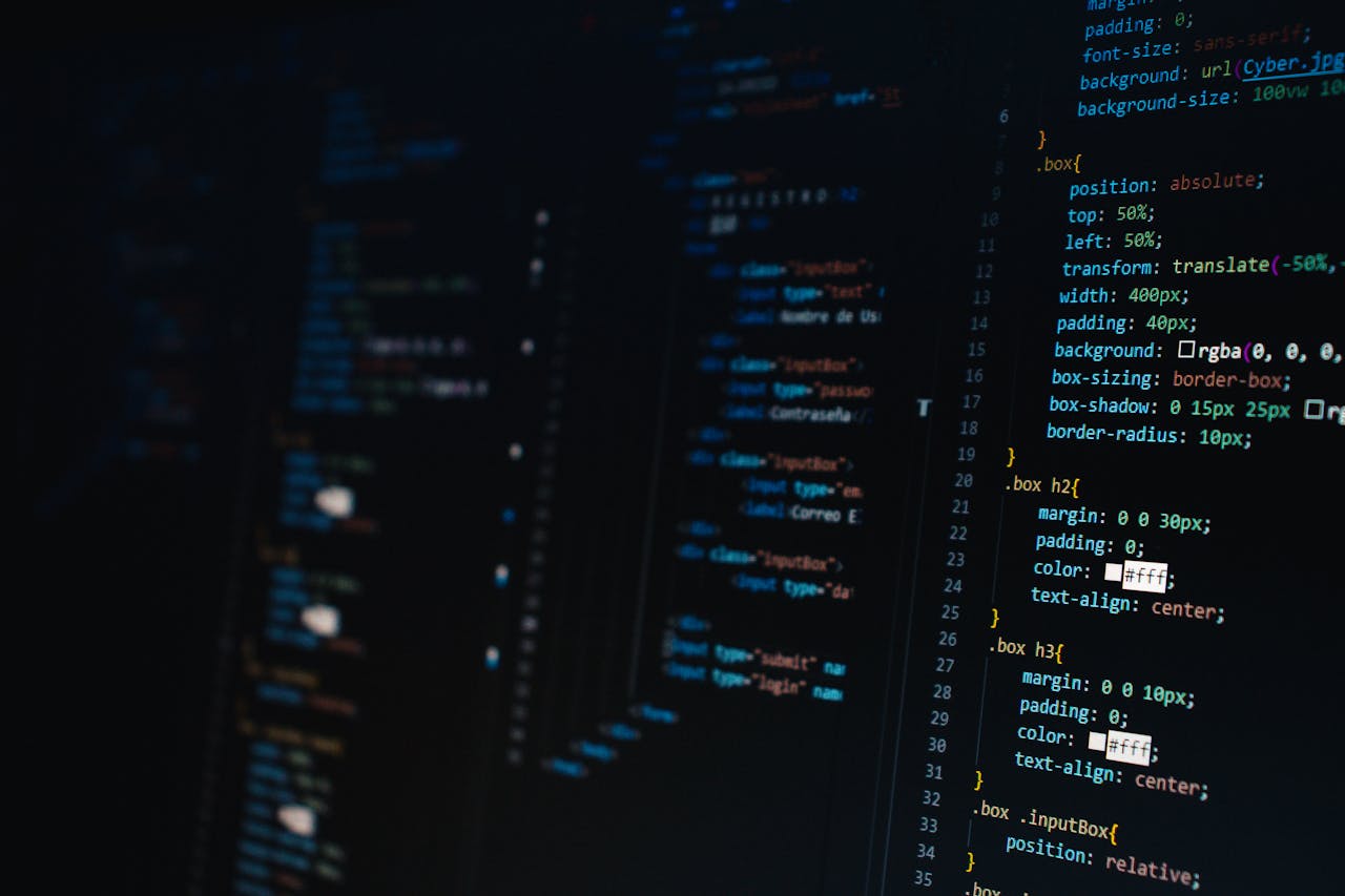 services-bg Detailed view of HTML and CSS code on a dark screen, representing modern web development.